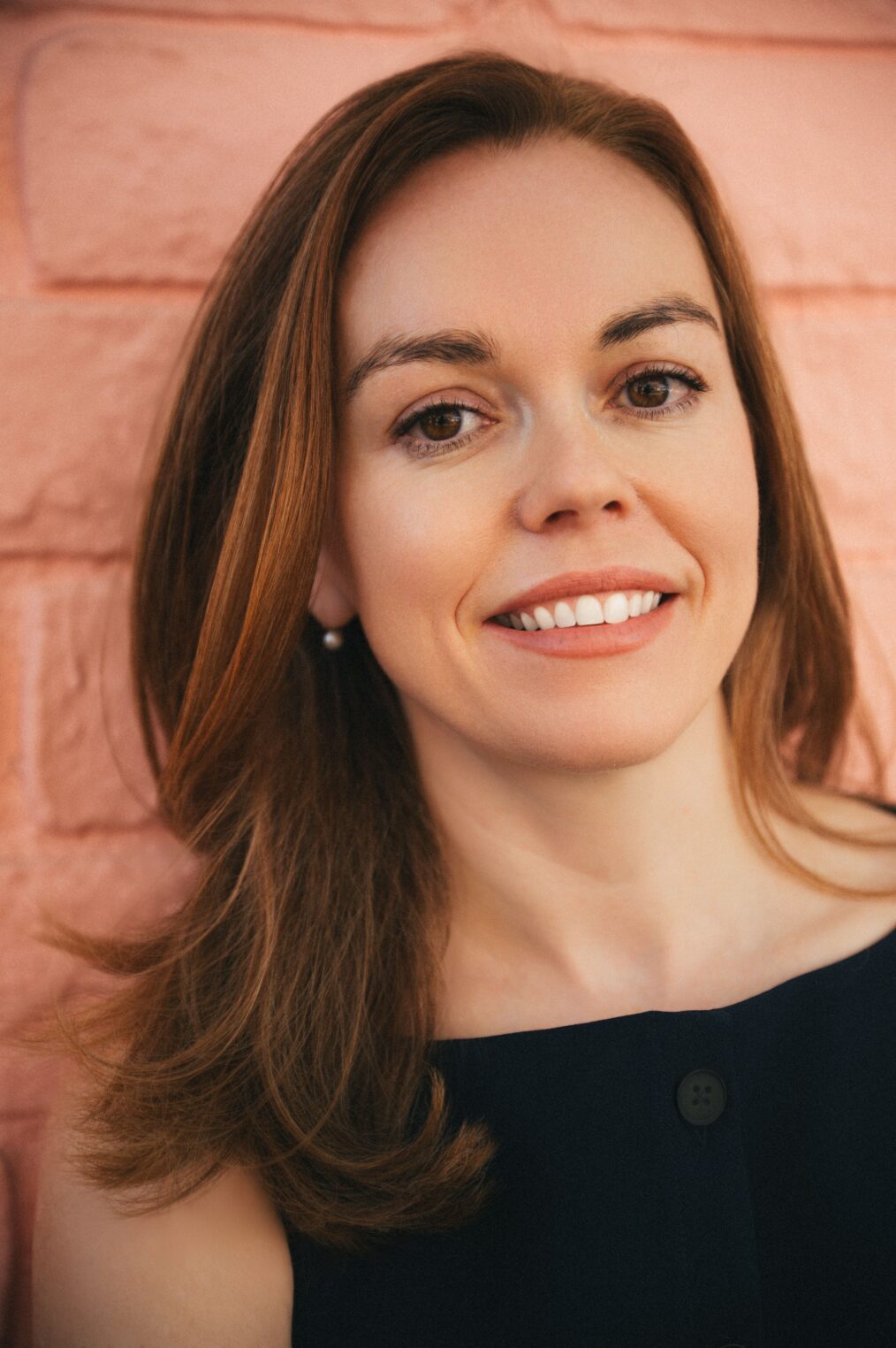 Rachael King, a brunette woman, smiles at the camera.
